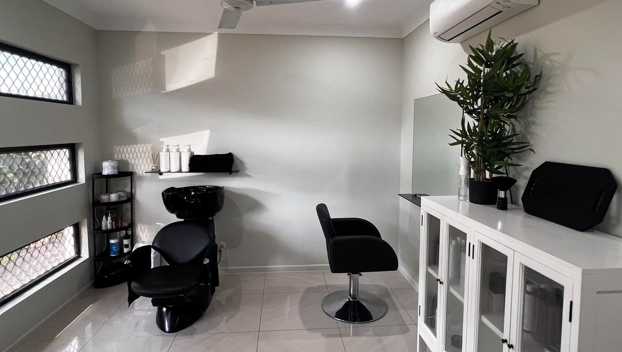 Modern salon interior at Sal’s Hair, Mount Peter, Queensland, AU with sleek chairs and stylish decor.