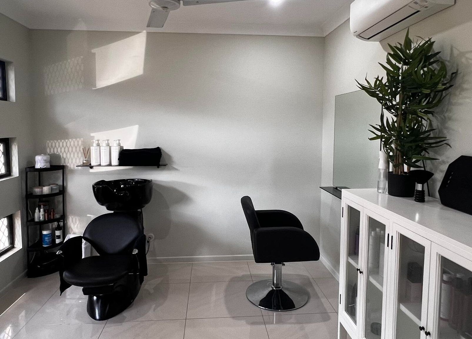 Modern salon interior at Sal’s Hair, Mount Peter, Queensland, AU with sleek chairs and stylish decor.