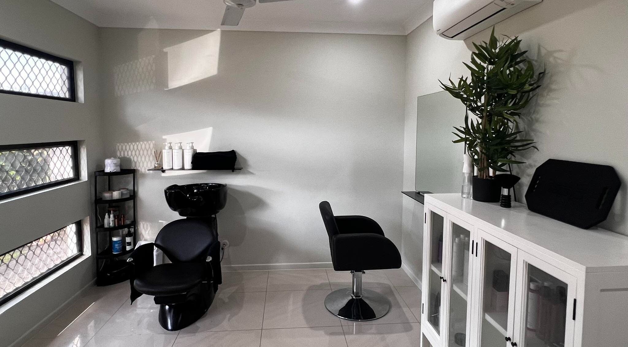 Modern salon interior at Sal’s Hair, Mount Peter, Queensland, AU with sleek chairs and stylish decor.