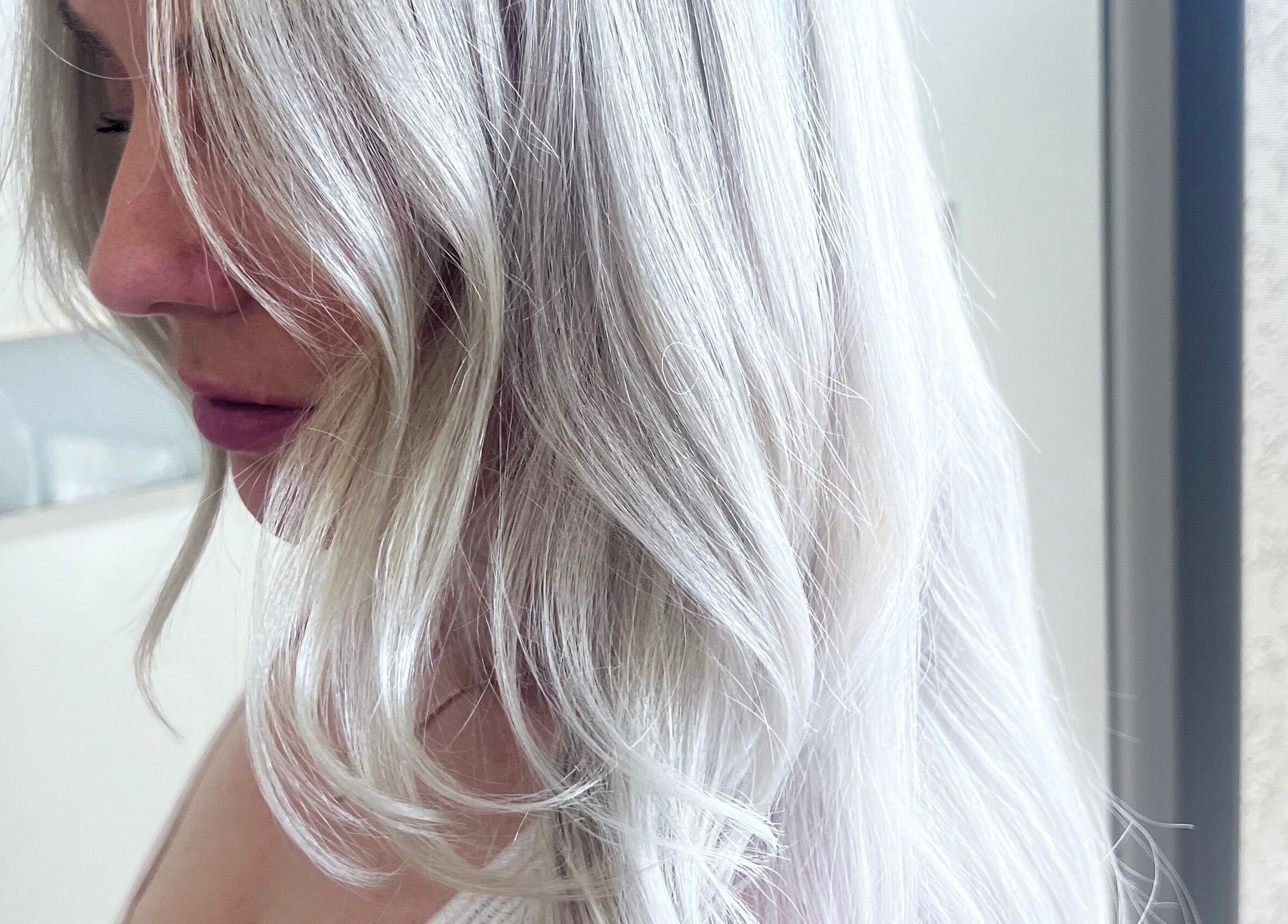 Beautiful silver hair styled at Sal’s Hair, Mount Peter, Queensland, AU, showcasing elegant blonde waves.