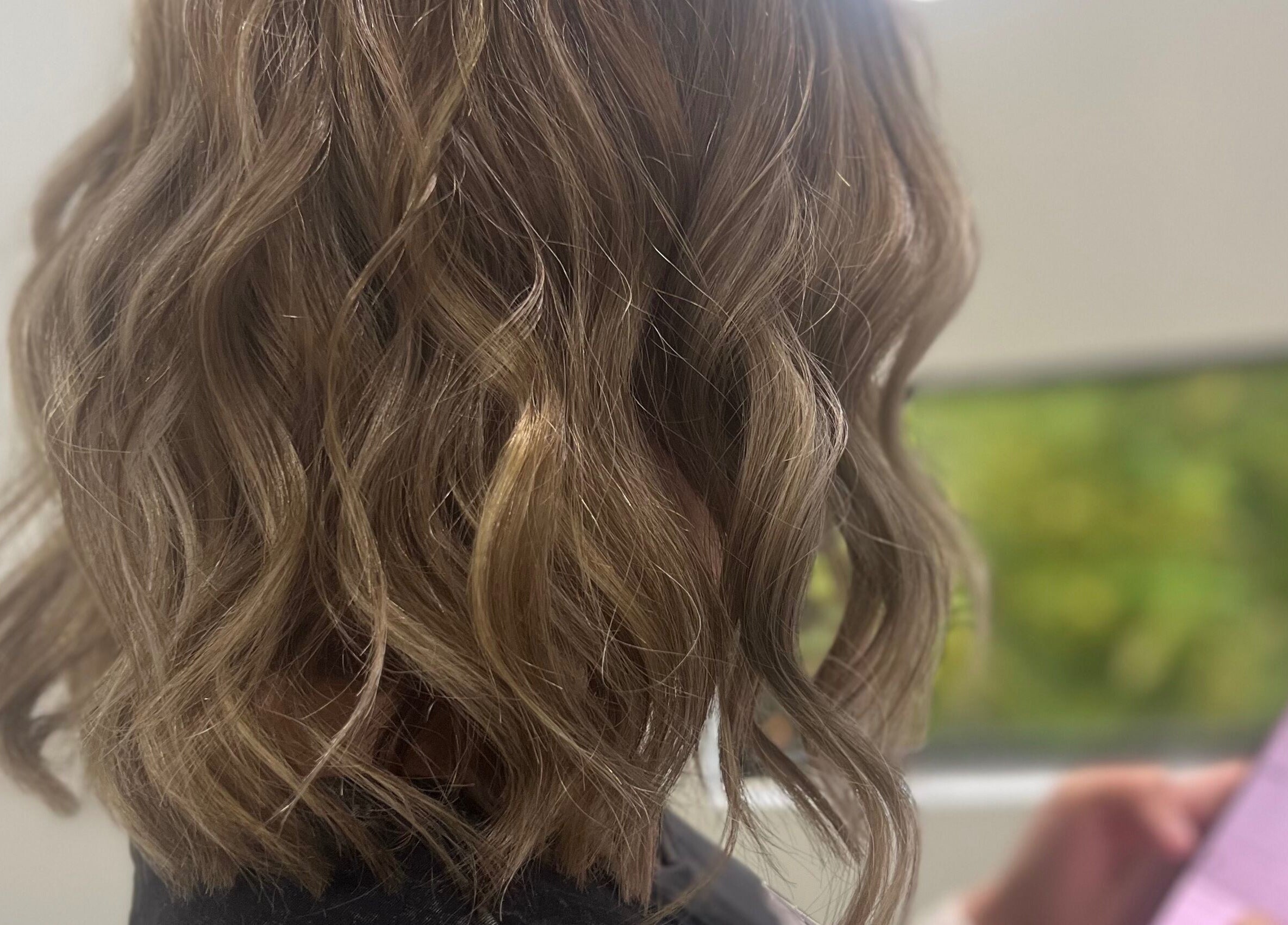Wavy blonde hairstyle at Sal’s Hair, Mount Peter, Queensland, AU.