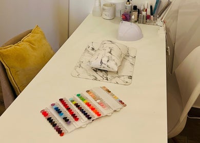 TOV Organic Salon Tas-sliema, MT nail station with colorful polish options and modern decor.