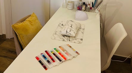 TOV Organic Salon Tas-sliema, MT nail station with colorful polish options and modern decor.