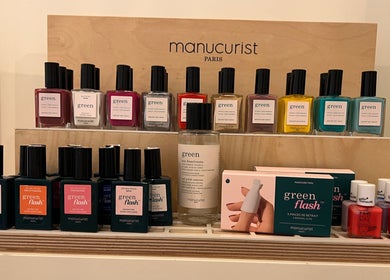 Colorful nail polishes on display at TOV Organic Salon, Tas-sliema, MT, featuring various vibrant shades.