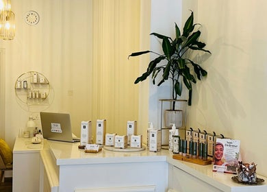 Reception area of TOV Organic Salon, Tas-sliema, MT, showcasing beauty products and serene decor.