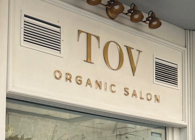 Front view of TOV Organic Salon's chic signage in Tas-sliema, MT showcasing gold lettering.