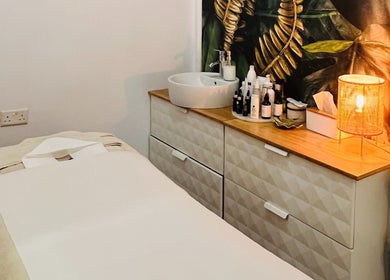 Relaxing treatment room at TOV Organic Salon, Tas-sliema, MT with cozy lighting and natural decor.