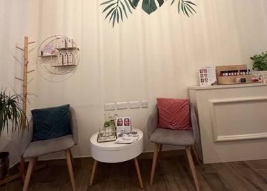 Relaxing seating area at TOV Organic Salon, Tas-sliema, MT, with chairs and a display of beauty products.