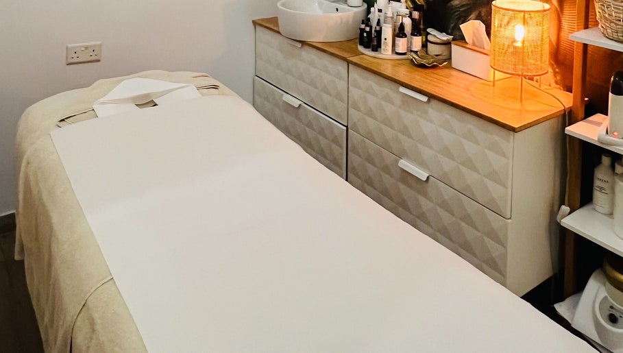 Treatment room with massage bed at TOV Organic Salon, Tas-sliema, MT. Relaxing ambiance for wellness services.