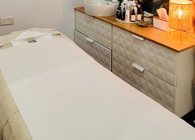 Treatment room with massage bed at TOV Organic Salon, Tas-sliema, MT. Relaxing ambiance for wellness services.