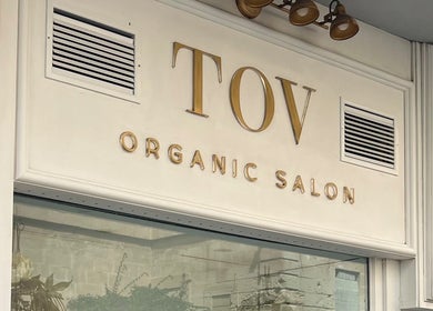 TOV Organic Salon exterior sign in Tas-sliema, MT showcases elegant gold lettering and modern design.