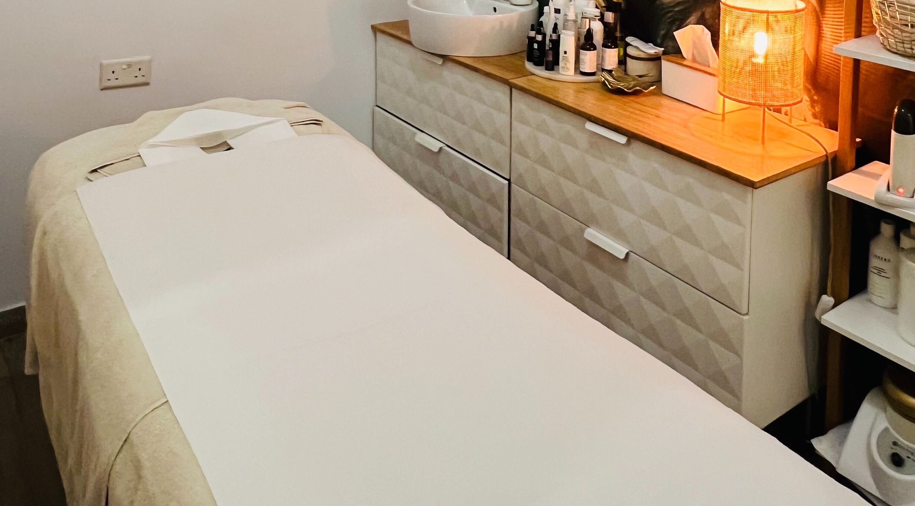 Relaxing treatment room at TOV Organic Salon, Tas-sliema, MT, with a cozy massage bed and ambient lighting.