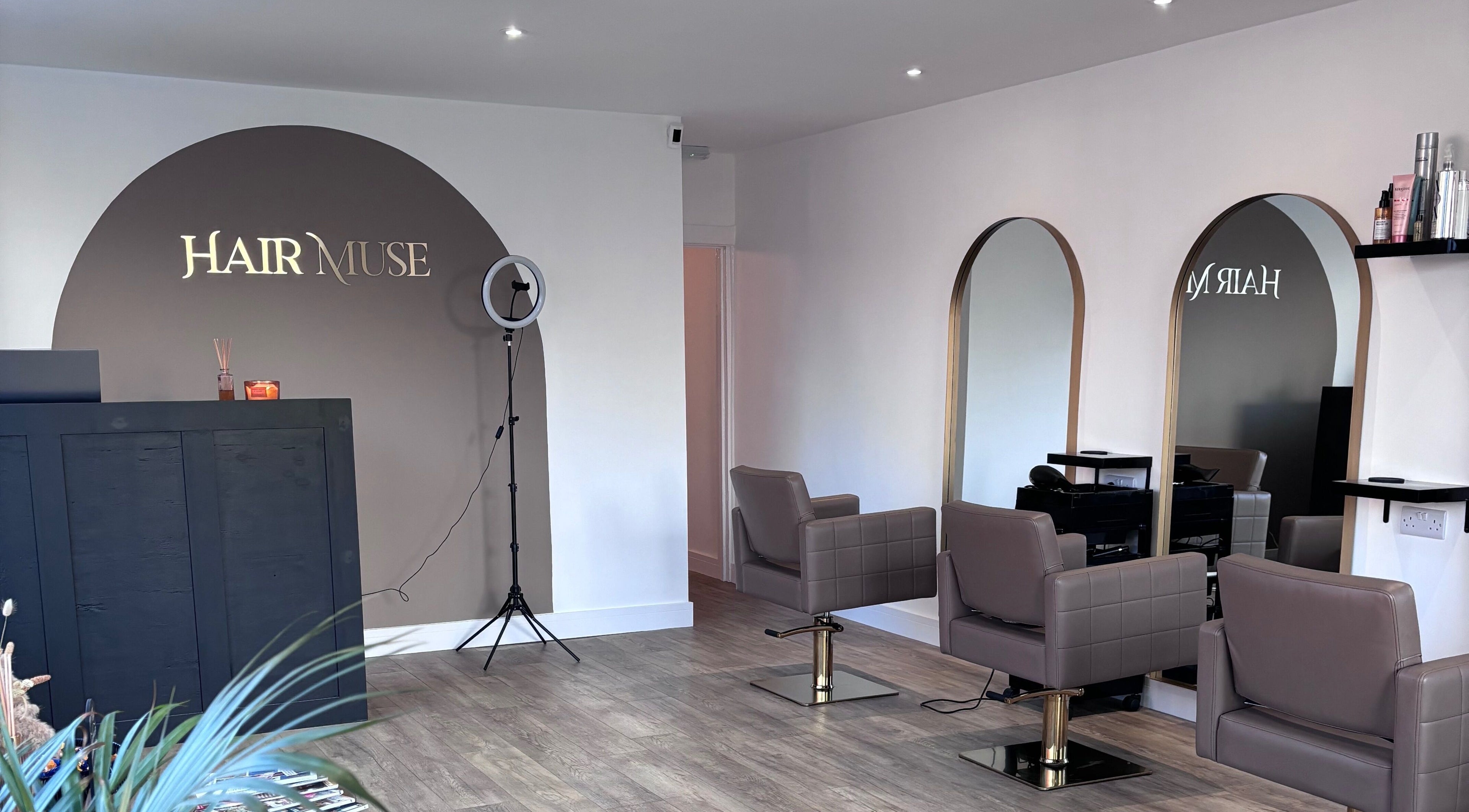 Interior of Hair Muse salon in Leicester, England, GB featuring modern styling chairs and elegant mirrors.