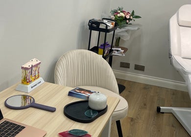 A serene treatment room at InStudio Aesthetics, London, England, GB, featuring a plush chair and beauty tools.