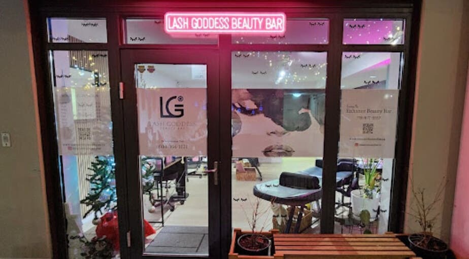 Entrance of Lash Goddess Beauty Bar in Coquitlam, BC, CA with a glowing pink sign.