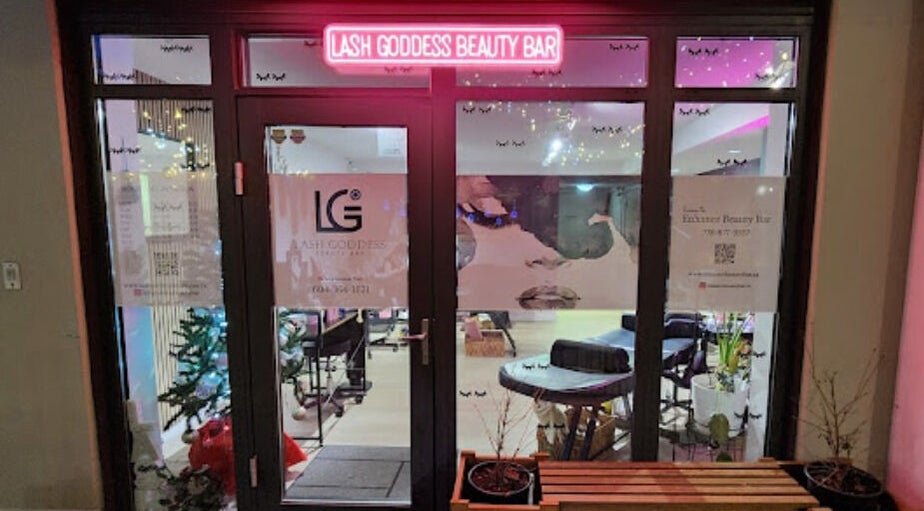 Entrance of Lash Goddess Beauty Bar in Coquitlam, BC, CA with a glowing pink sign.