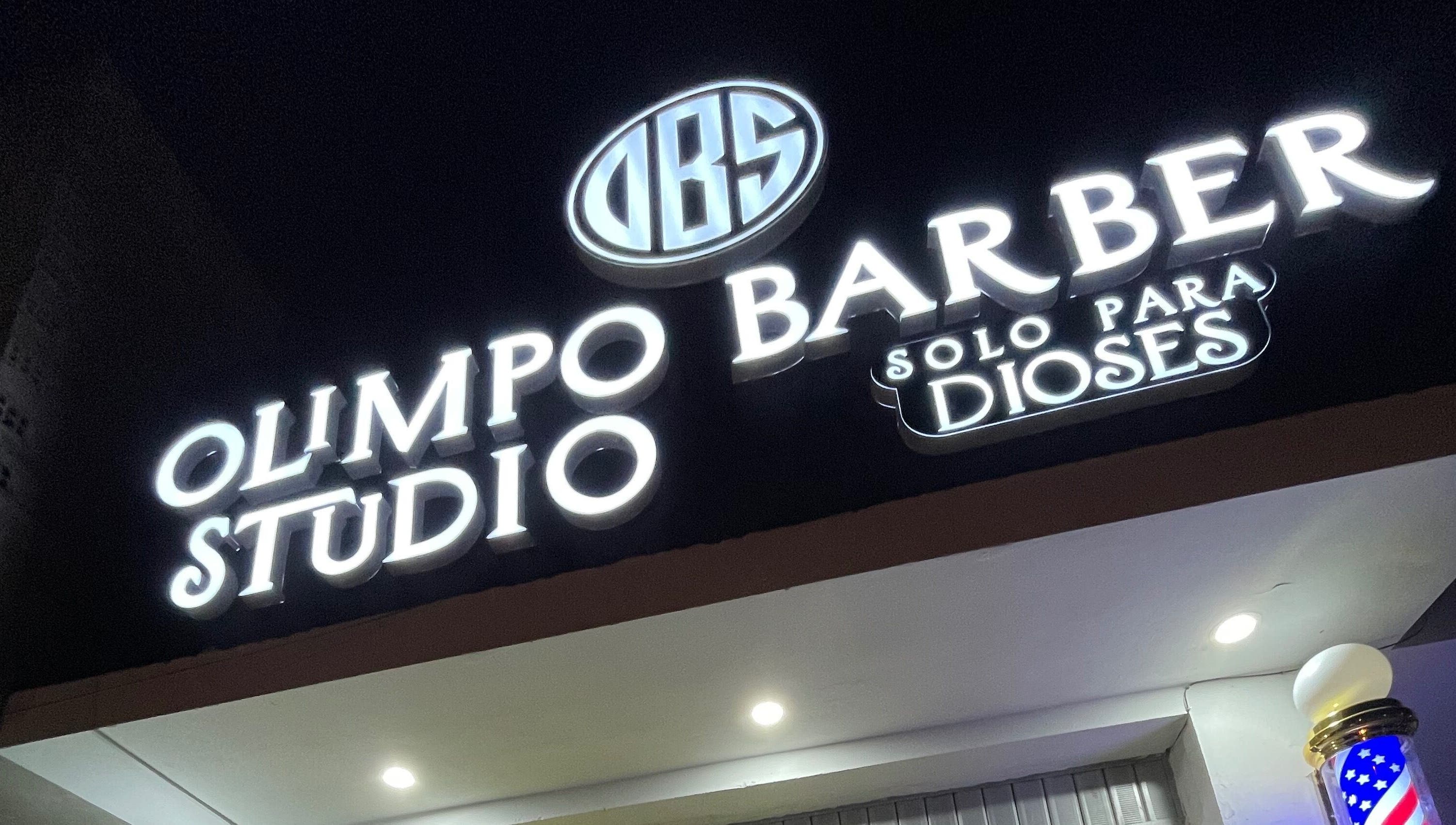 Exterior del Olimpo barber studio iluminado por la noche en Chimbote, Áncash, PE.