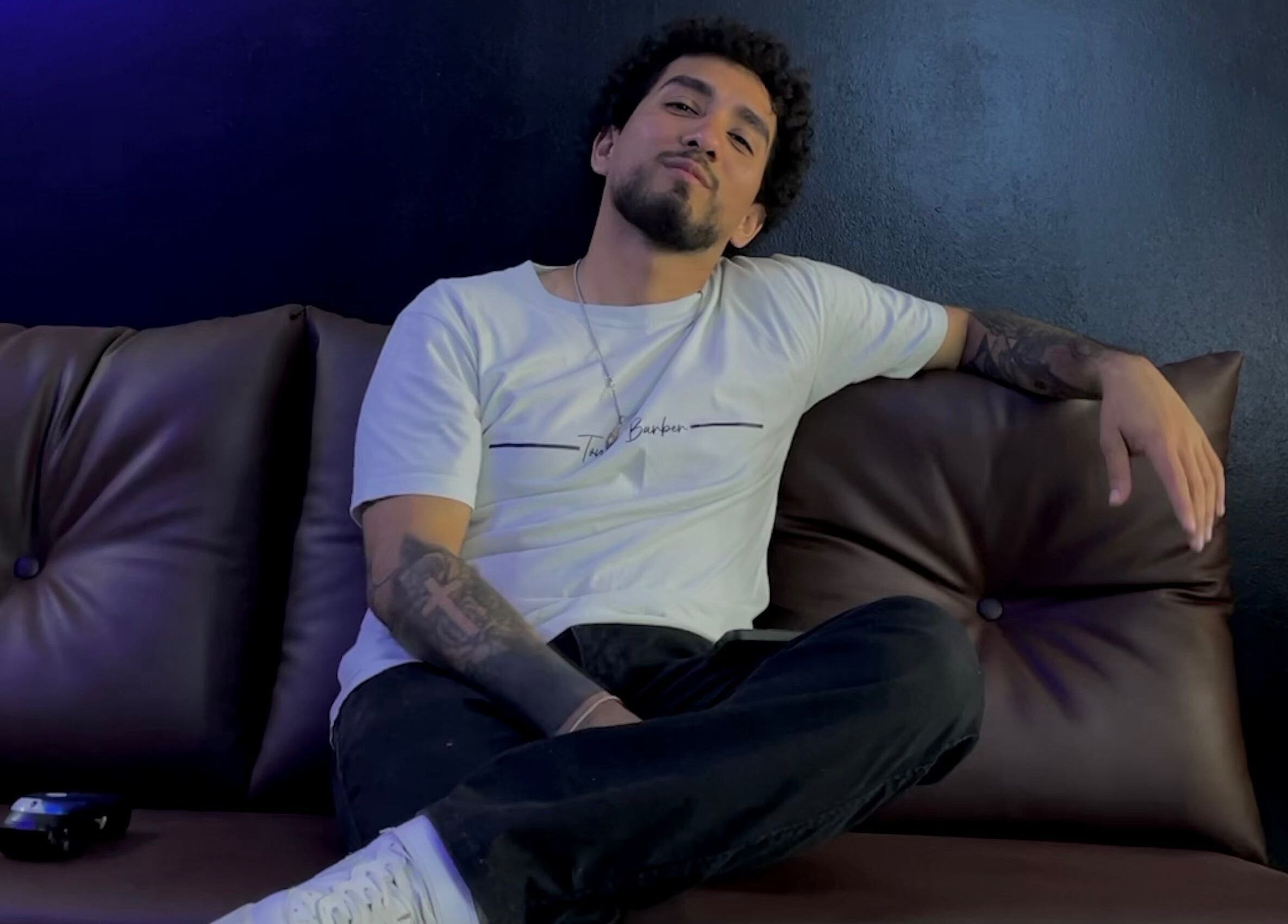 Hombre relajado en sofá de Olimpo barber studio, Chimbote, Áncash, PE.