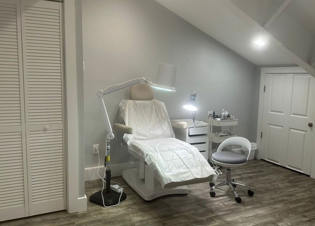 Comfortable treatment chair at Pink Lemonade Beauty Plaza, Key West, Florida, US, under warm lighting.