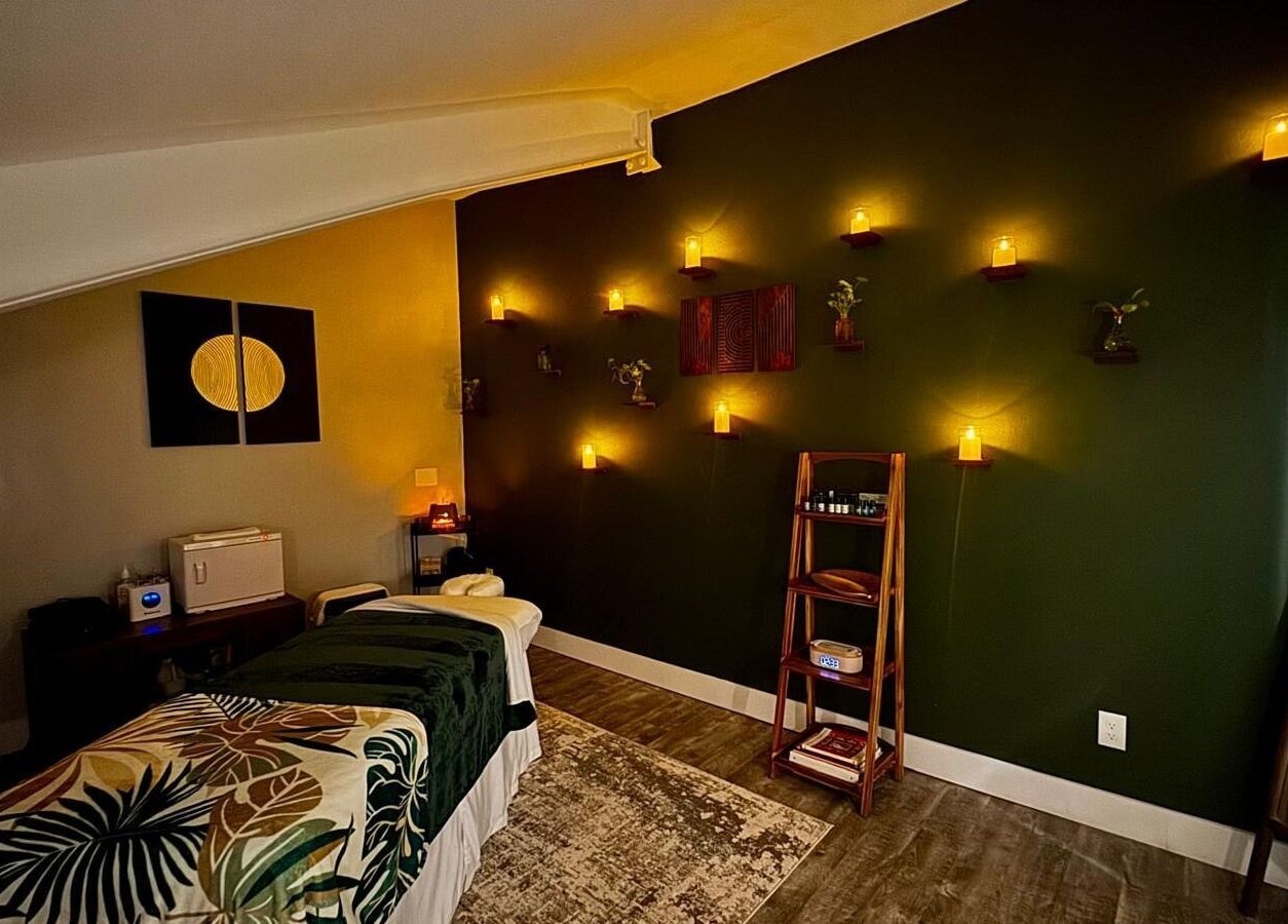 Tranquil massage room at Pink Lemonade Beauty Plaza, Key West, Florida, US, with ambient lighting and decor.