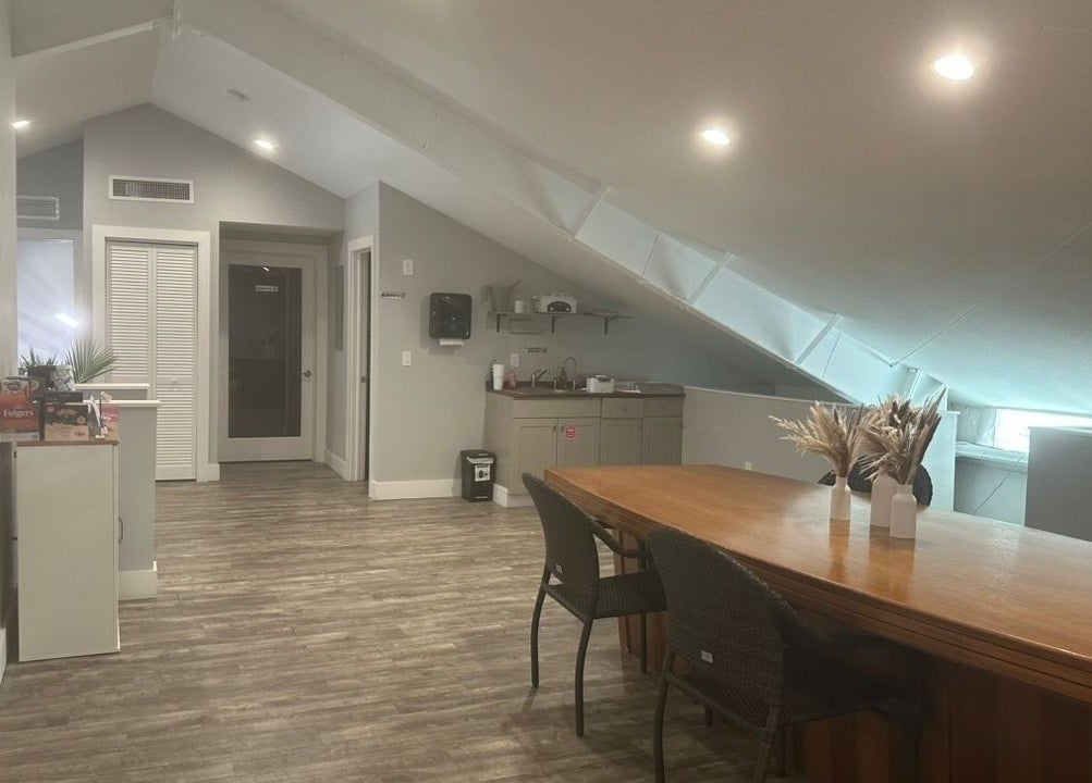 Spacious interior of Pink Lemonade Beauty Plaza in Key West, Florida, showcasing modern design and warm ambiance.