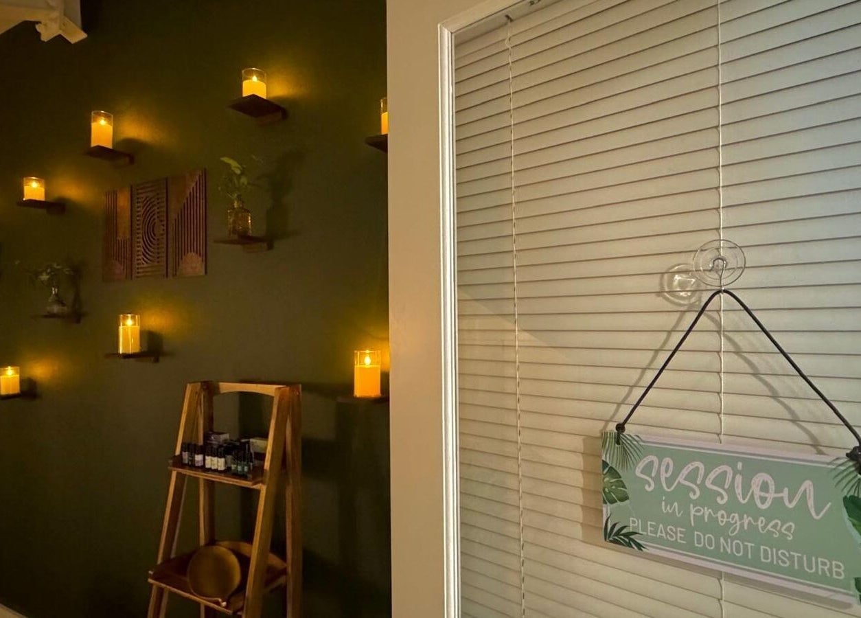 Candlelit room with 'Session in Progress' sign at Pink Lemonade Beauty Plaza, Key West, Florida, US.