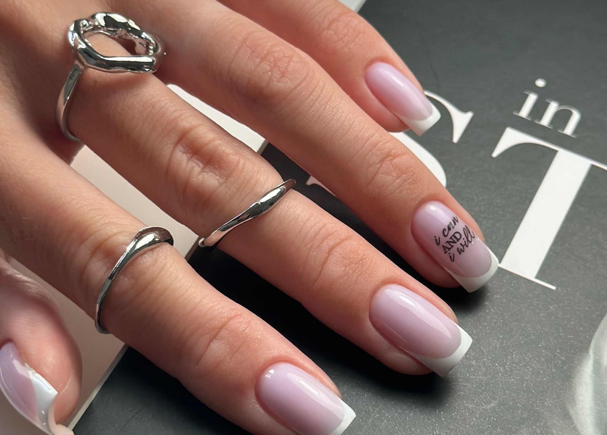 Elegant nail art at Pink Lemonade Beauty Plaza, Key West, Florida, US showcasing classic French manicure.