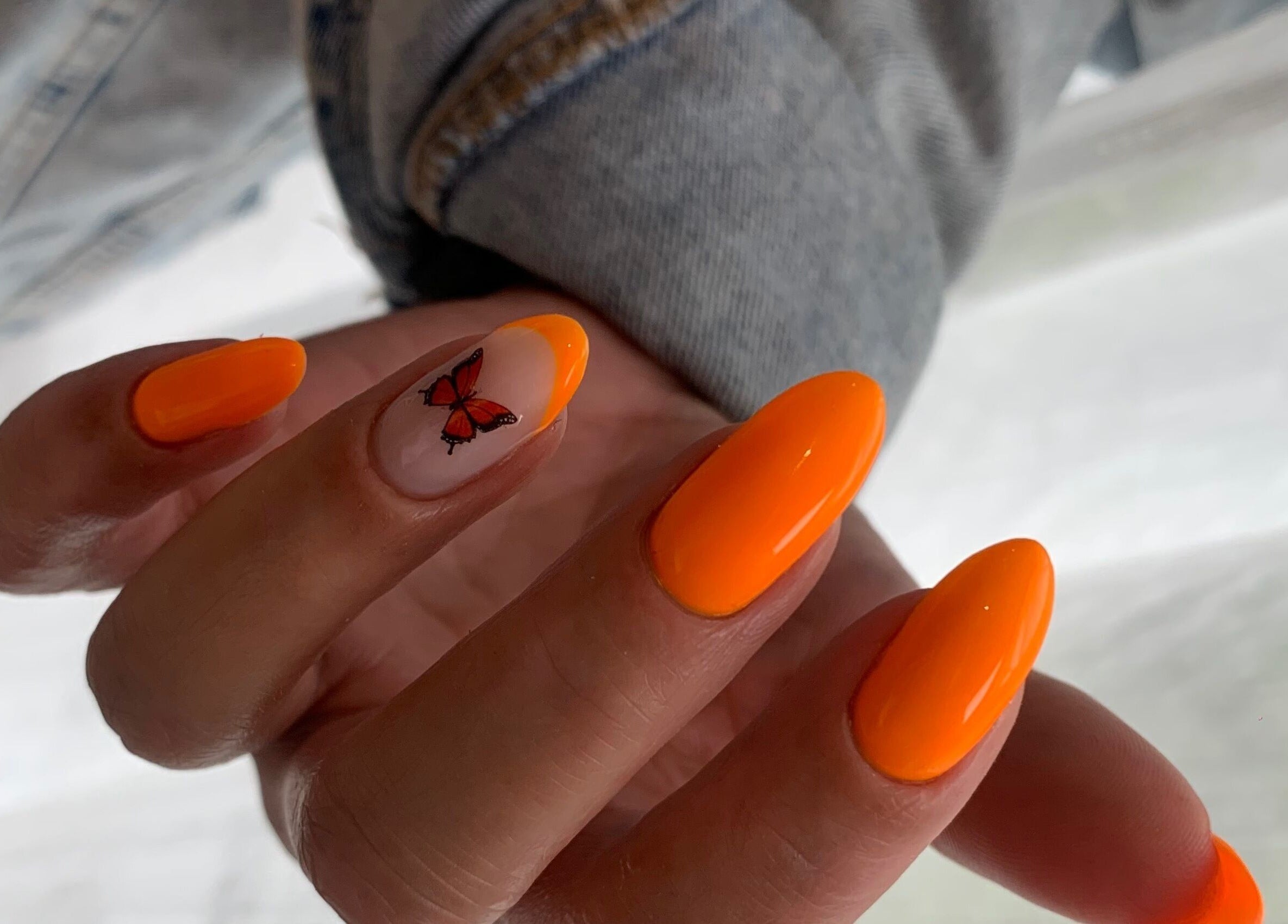 Bright orange and butterfly nail art at Pink Lemonade Beauty Plaza, Key West, Florida, US.