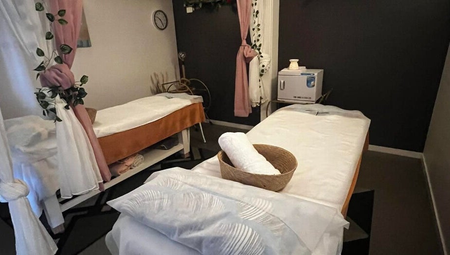 Relaxing treatment room at Flex Beauty and Aroma, Bundall, Queensland, AU with cozy decor and massage beds.