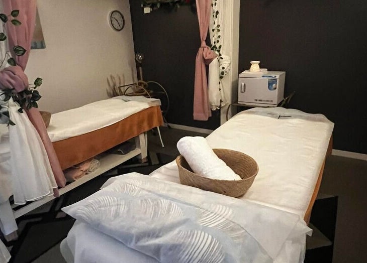 Relaxing treatment room at Flex Beauty and Aroma, Bundall, Queensland, AU with cozy decor and massage beds.