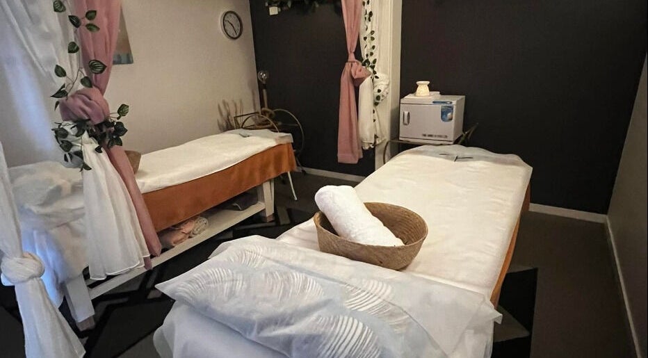 Relaxing treatment room at Flex Beauty and Aroma, Bundall, Queensland, AU with cozy decor and massage beds.