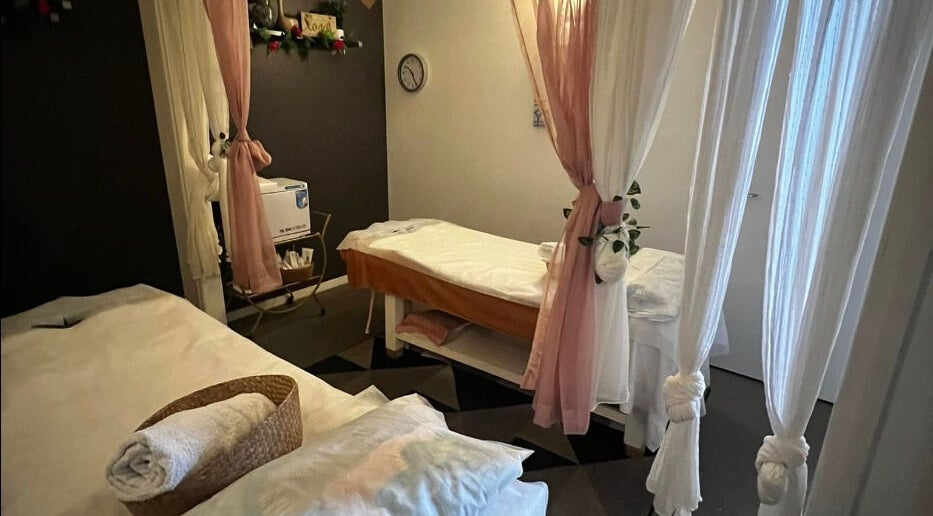 Relaxation room at Flex Beauty and Aroma in Bundall, Queensland, AU, featuring massage beds and gentle lighting.
