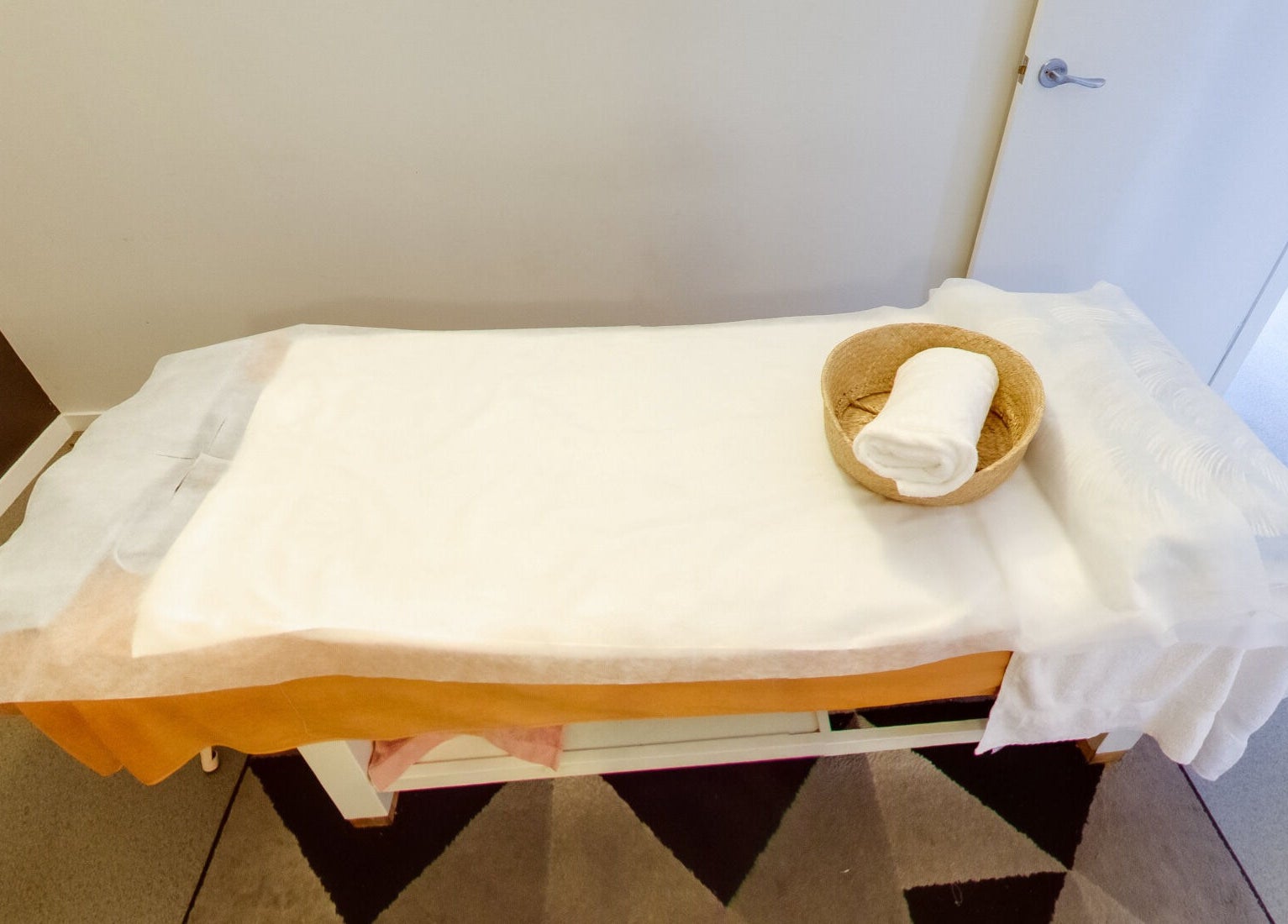 Relaxing spa bed setup at Flex Beauty and Aroma in Bundall, Queensland, AU with towel and basket.