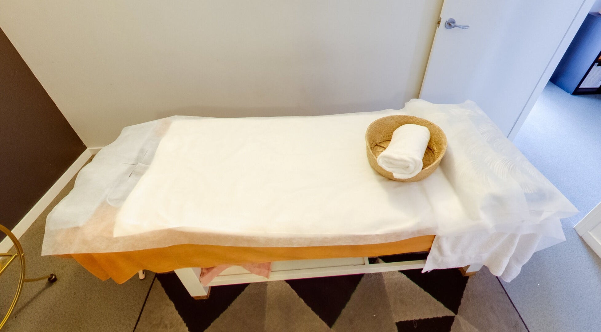 Relaxing spa bed setup at Flex Beauty and Aroma in Bundall, Queensland, AU with towel and basket.