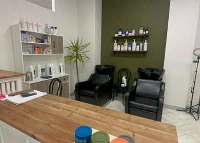Modern interior of AM Beauty Hair Salon in Gympie, Queensland, AU featuring styling chairs and products.