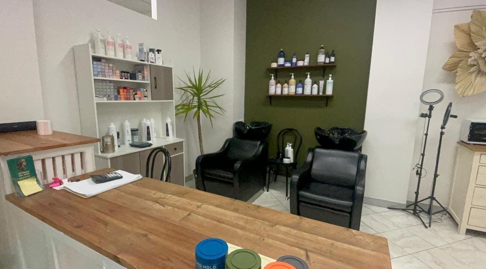 Modern interior of AM Beauty Hair Salon in Gympie, Queensland, AU featuring styling chairs and products.