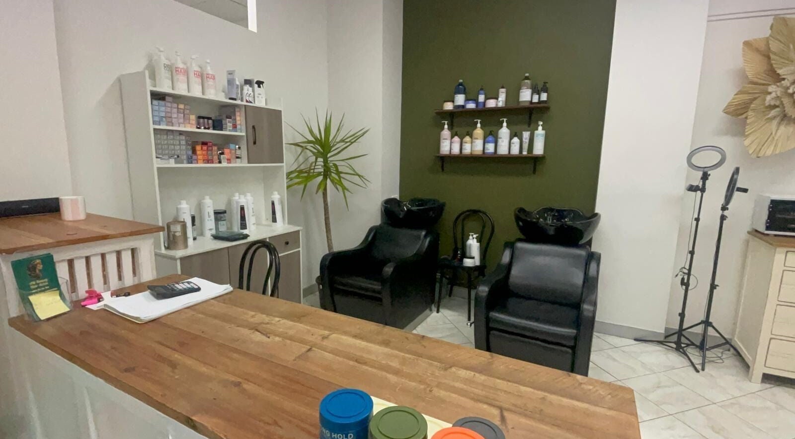 Modern interior of AM Beauty Hair Salon in Gympie, Queensland, AU featuring styling chairs and products.
