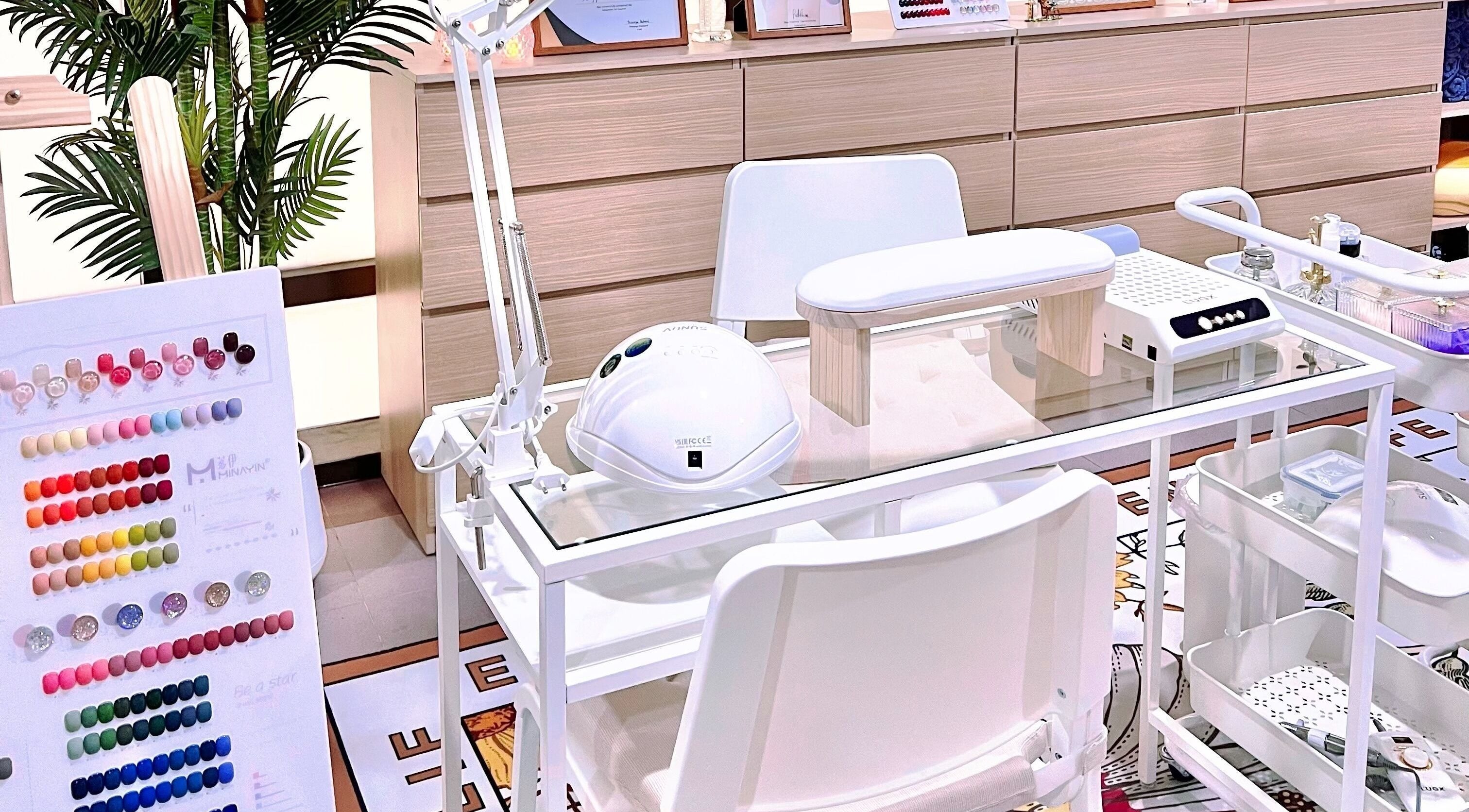 Homey Nail Spa in Bangkok, TH showcases a modern manicure station with colorful polish options and sleek decor.
