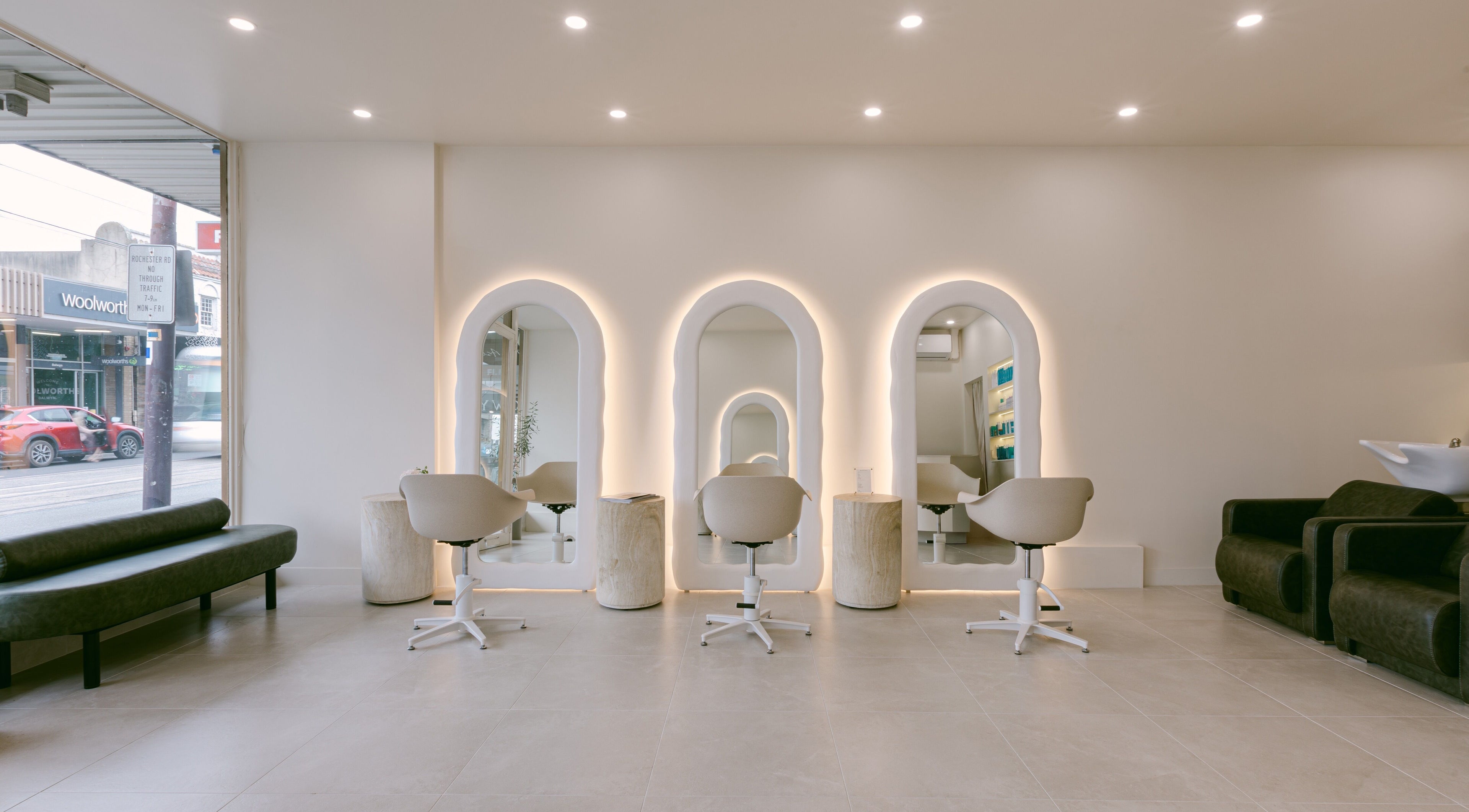 Chic interior at Ador Hair Co., Melbourne, Victoria, AU with arched mirrors and stylish seating.