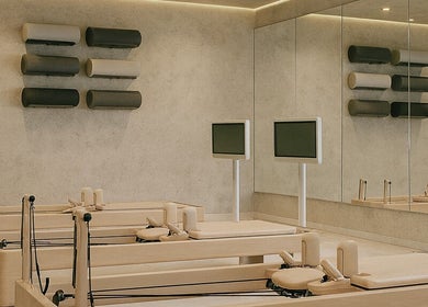 Pilates reformers at Being | Fourways in Sandton, Gauteng, ZA, offering a serene workout setting.