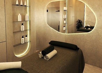 Luxurious spa room at Being | Fourways, Sandton, Gauteng, ZA. Soft lighting, plush linens, and elegant decor.