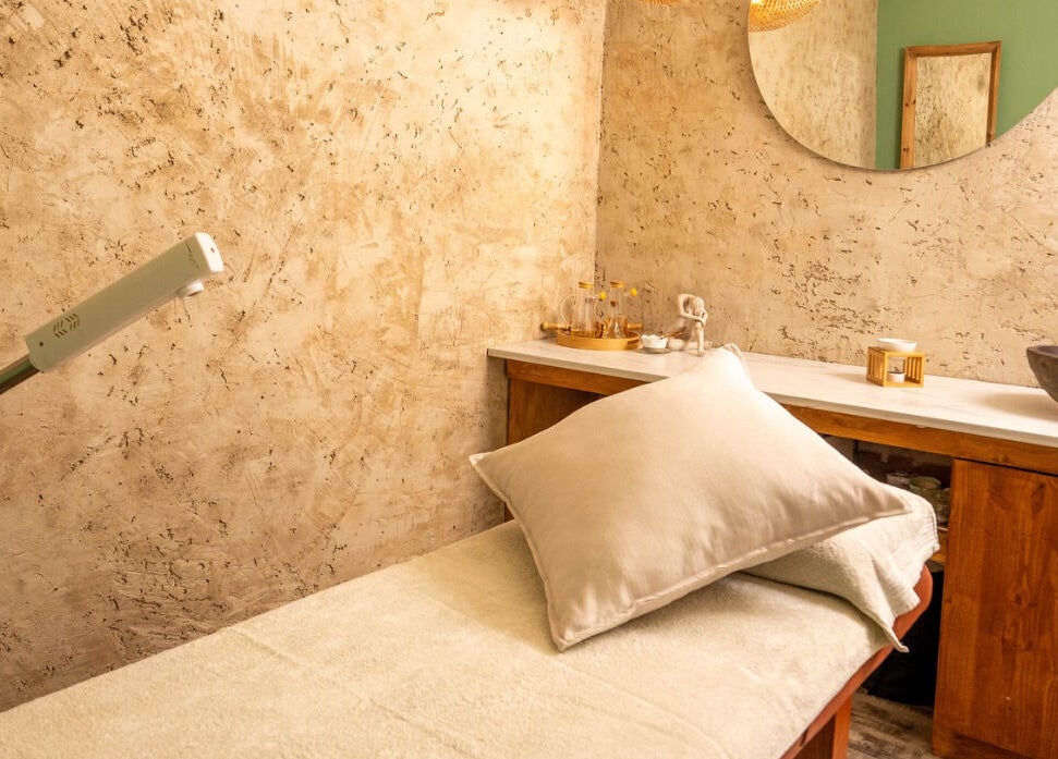 Cozy treatment room at being | Morningside, Sandton, Gauteng, ZA featuring a massage table and ambient lighting.