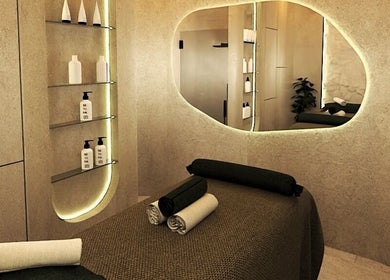 Calming spa room at Being | Fourways, Sandton, Gauteng, ZA, with massage bed and ambient lighting.