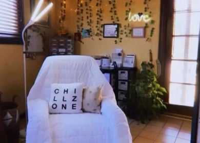 Relaxing corner at Jewels Lashes in Glendale, California, US with comfy chair and cozy decor.