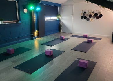 Serene yoga room at Lauren Louise Wellness in Biggleswade, England, GB with mats and blocks prepared for a session.
