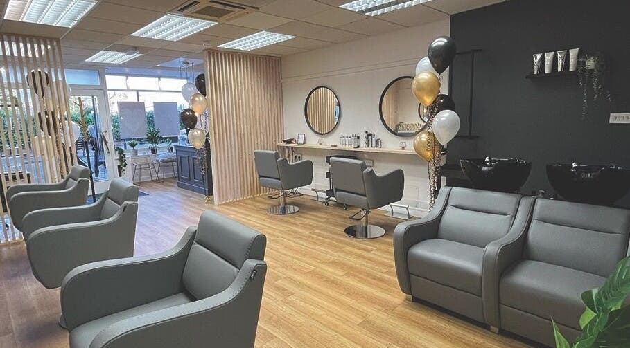 Modern salon interior at Heaven Hair & Beauty, Chatteris, England, GB with stylish chairs and decor.