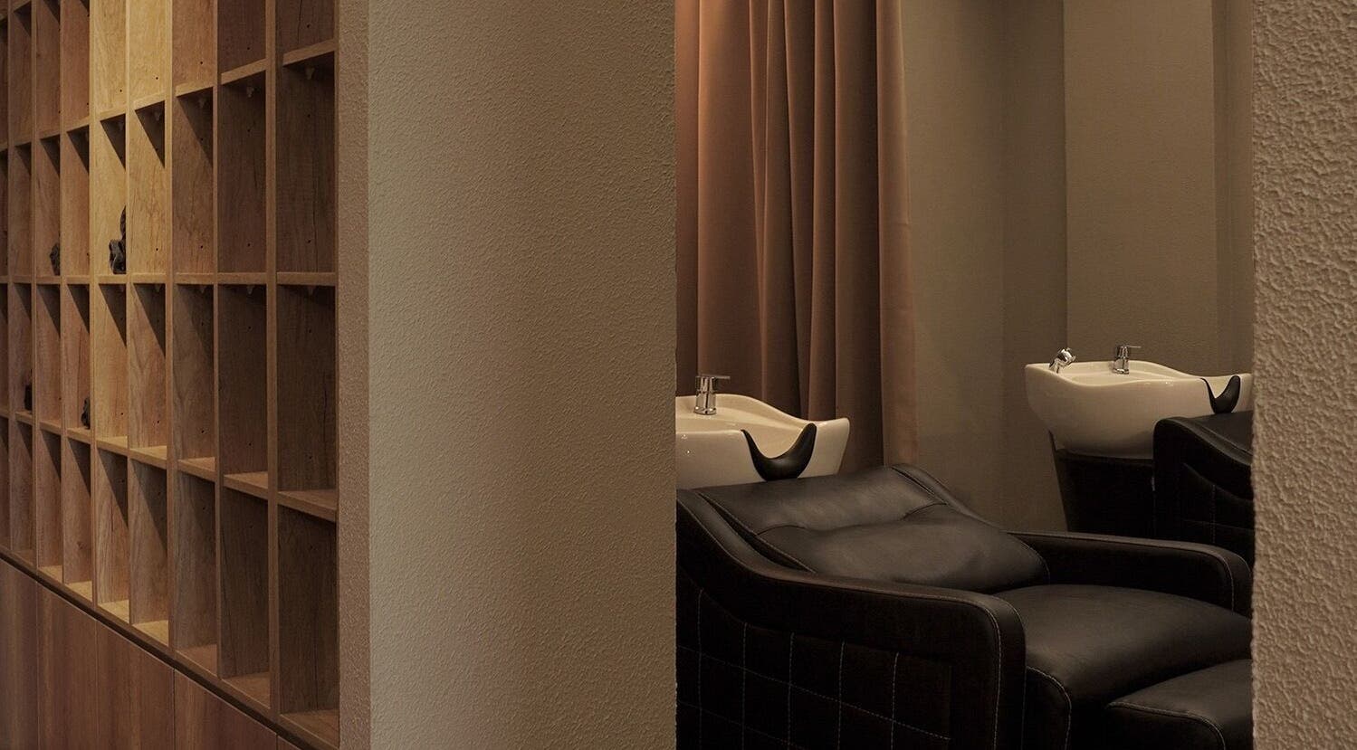 Elegant wash area at Hairkunst 13 Salon in Shah Alam, Selangor, MY showcasing luxury seating and wooden decor.