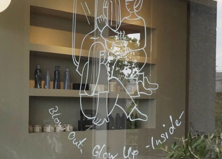 Artistic window display at Hairkunst 13 Salon, Shah Alam, Selangor, MY with haircare products on shelves.