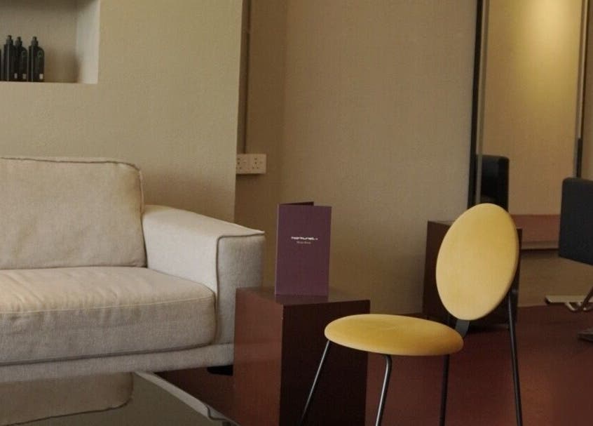 Cozy seating area in Hairkunst 13 Salon, Shah Alam, Selangor, MY, featuring a stylish sofa and modern chair.