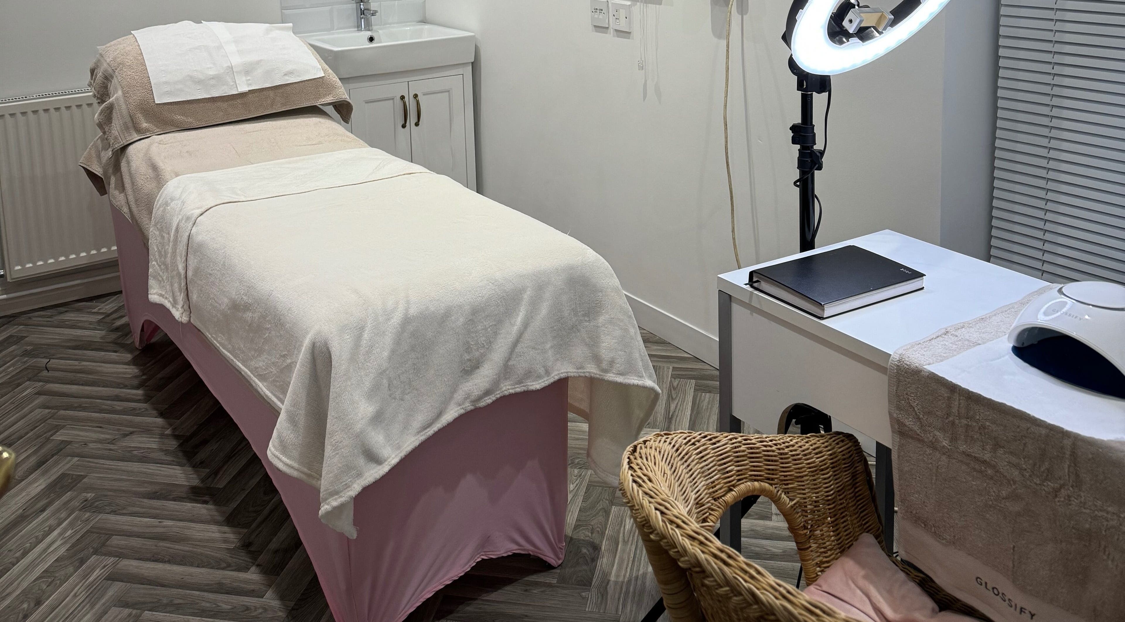 Relaxing treatment room at Blossom Salon, Shrewsbury, England, GB. Features a cozy massage table and modern decor.